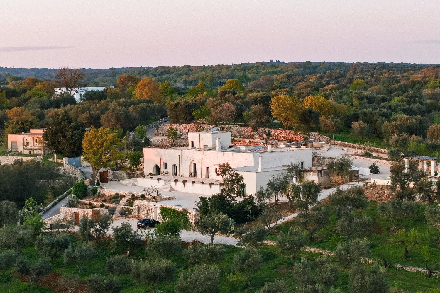 Villa Lucantu aerial exterior view with stone architecture and olive groves, Cisternino, Puglia, Italy