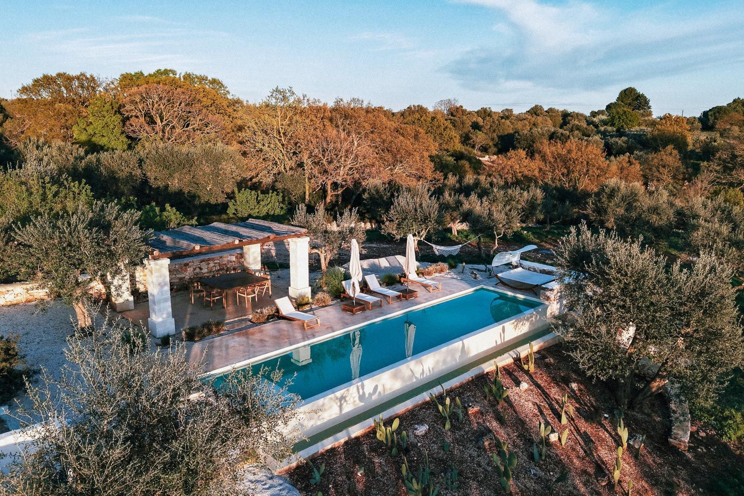 Villa Lucantu infinity pool with stone pergola and countryside views, Cisternino, Puglia, Italy