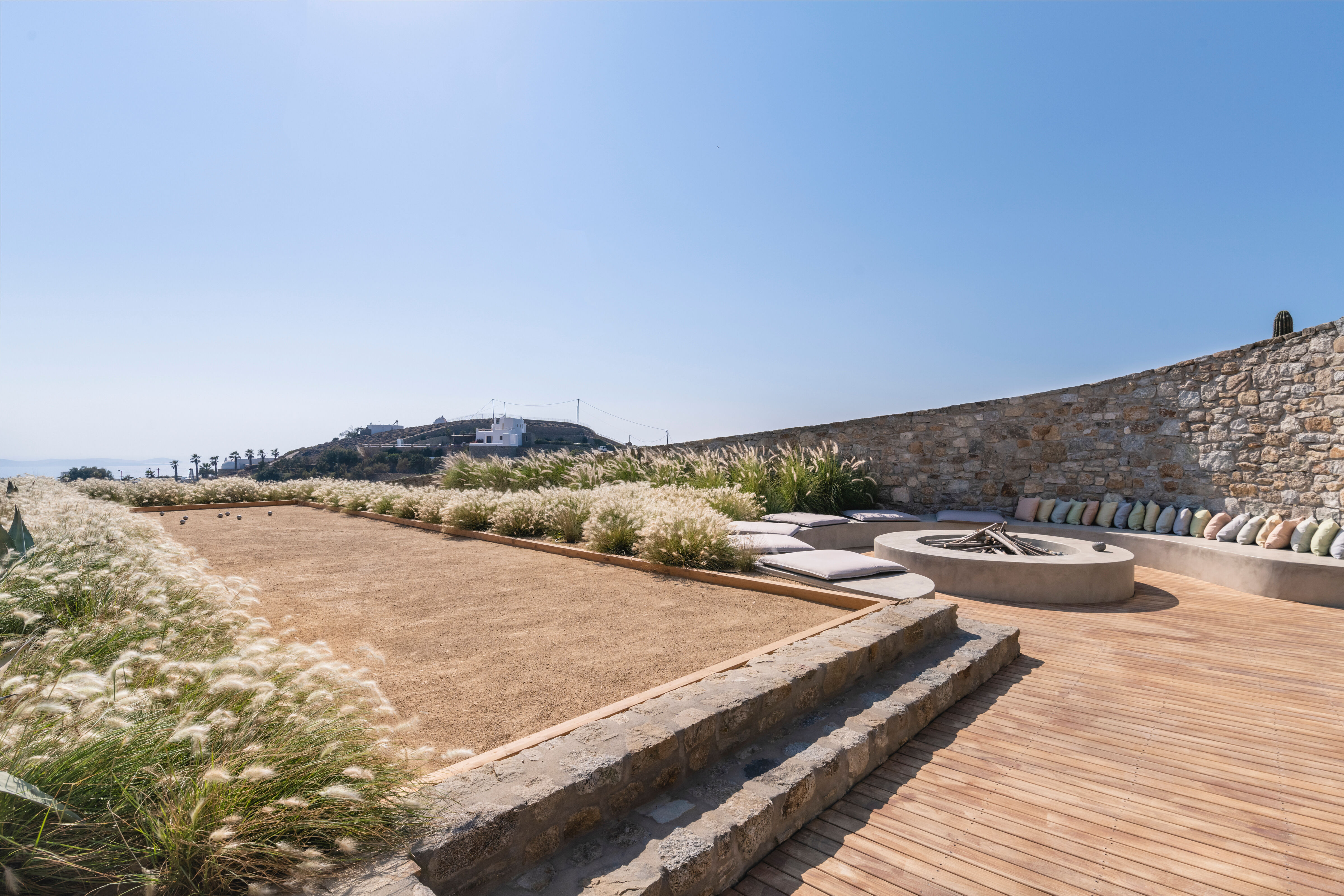 Villa Iliada outdoor terrace with circular fire pit and lounge seating, Mykonos, Greece