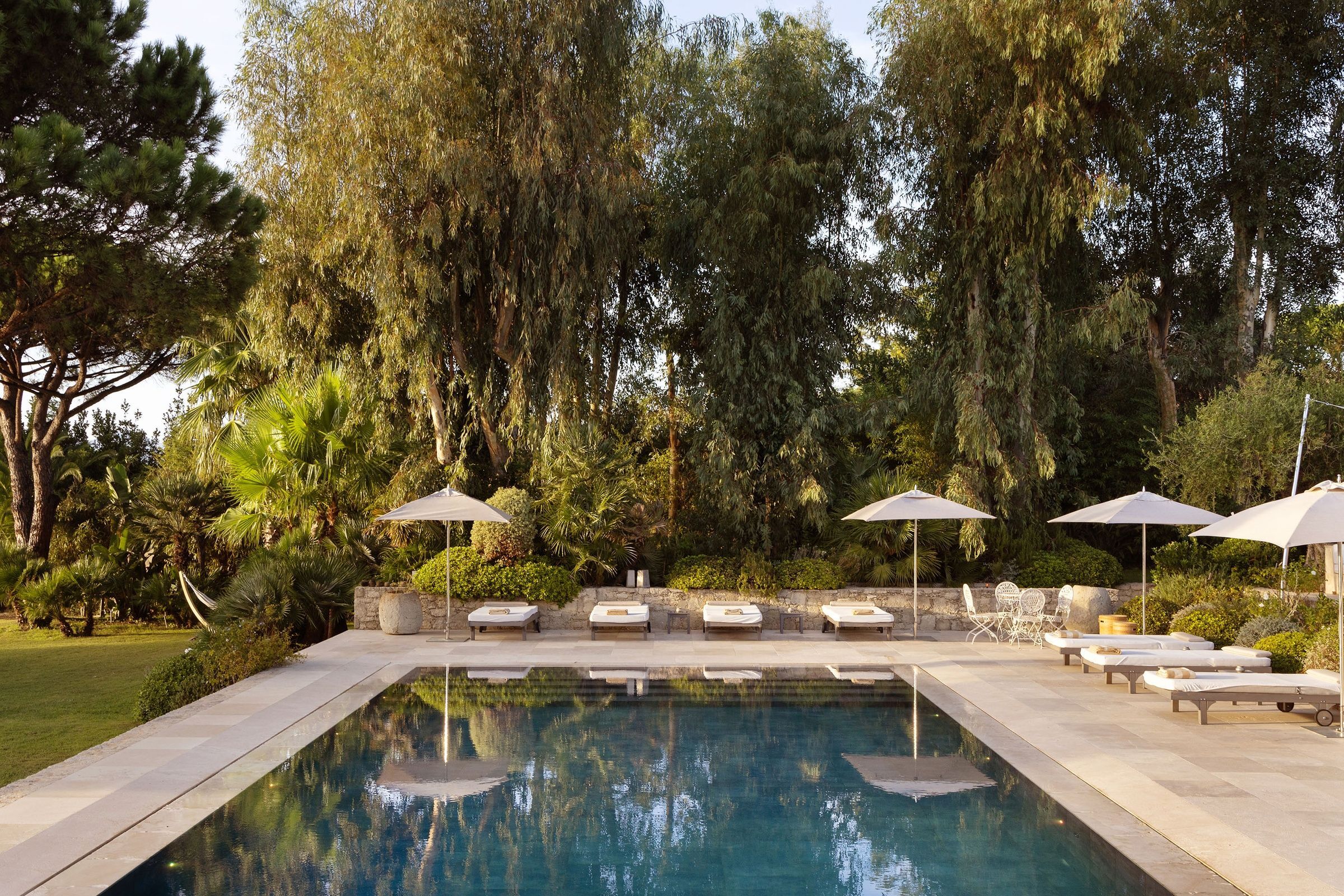 Villa Maï Taï pool deck with designer loungers and umbrellas, Saint-Tropez Peninsula, France