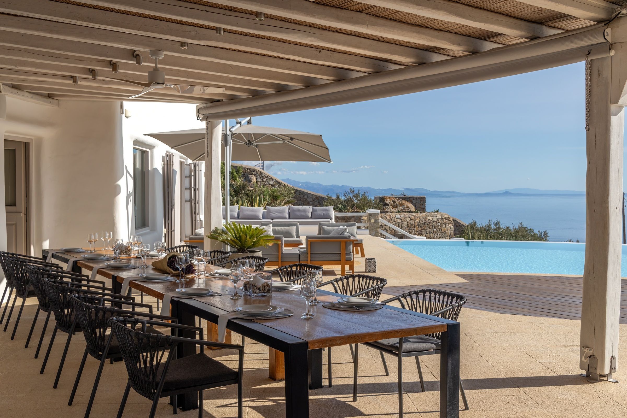 Villa Infinite Breeze aerial view with curved infinity pool and terraces, Mykonos, Greece
