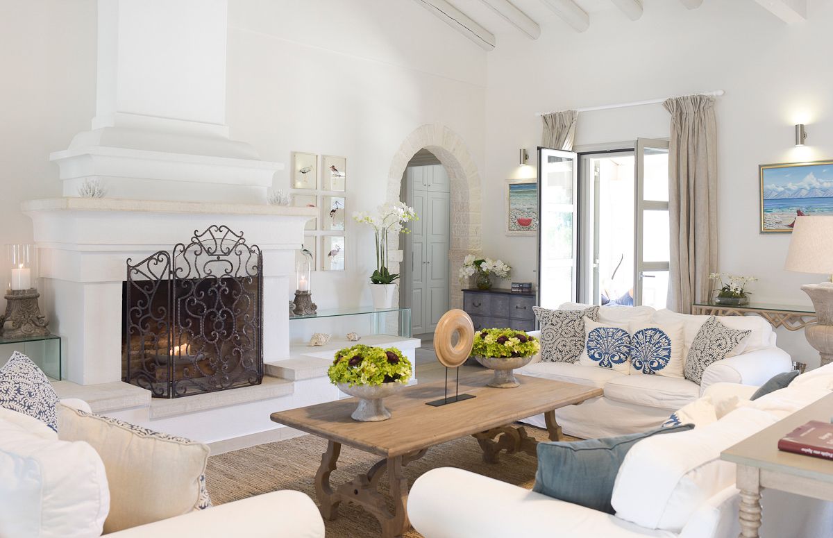 Villa Pearl main living room with exposed beams and fireplace, Kassiopi, Greece