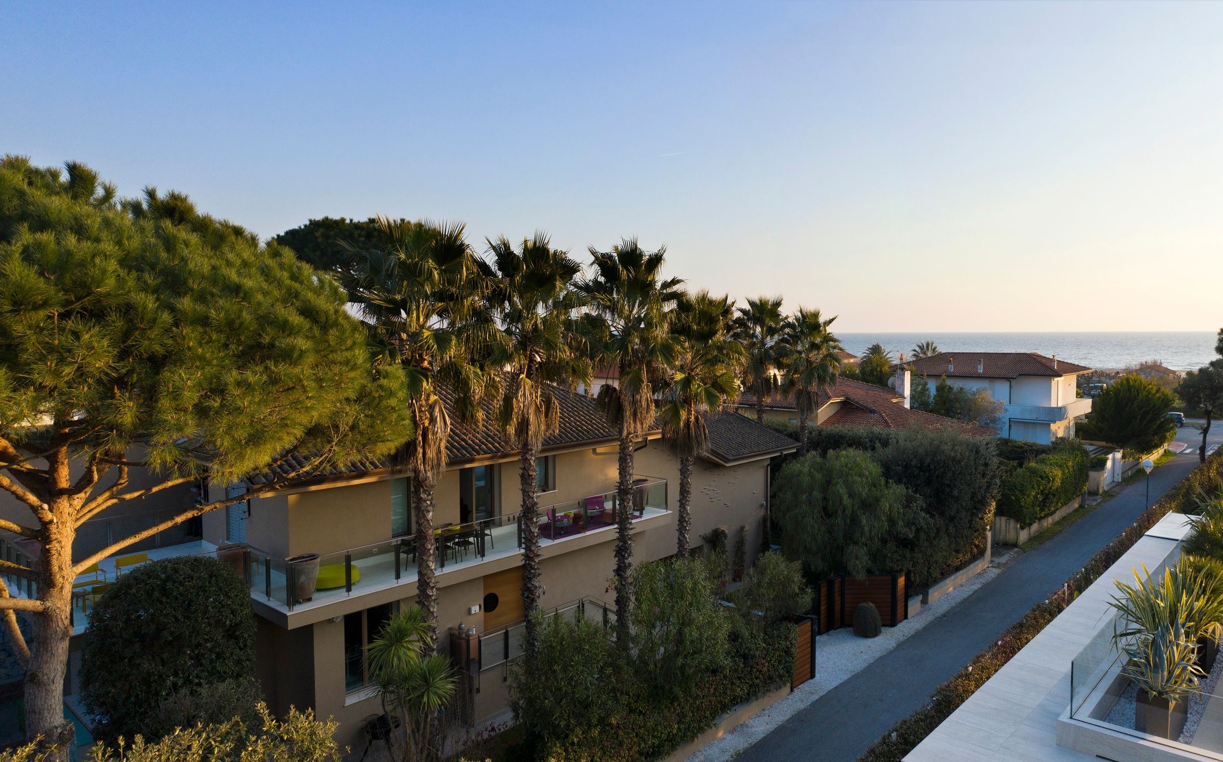 Villa Oblò aerial view with palm trees and coastal architecture, Forte dei Marmi, Tuscany, Italy